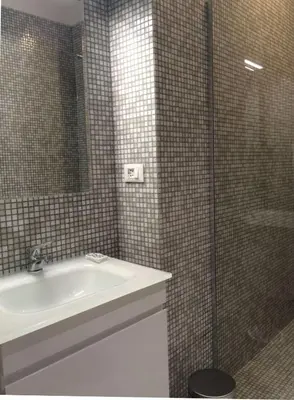 a bathroom with a sink and a glass shower at Tuttelestrade - The apartment in Rome