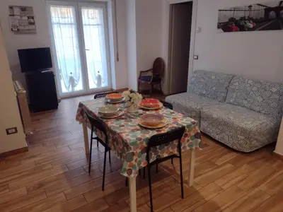 a table with dishes on it in a living room at La casa per te in Rome