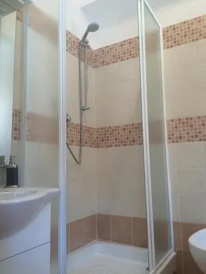 a shower with a glass door in a bathroom at La casa per te in Rome