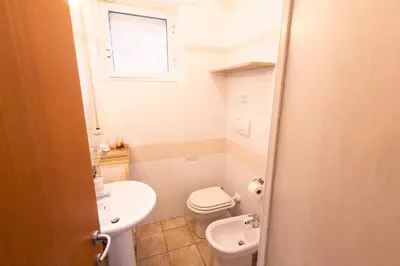 a small bathroom with a toilet and a sink at TOM'S HOUSE in Rome