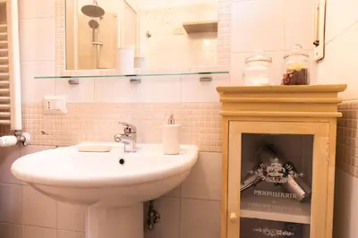 a bathroom with a sink and a mirror at TOM'S HOUSE in Rome