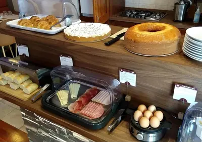 a display case with many different types of bread and pastries at J24 B&B in Rome