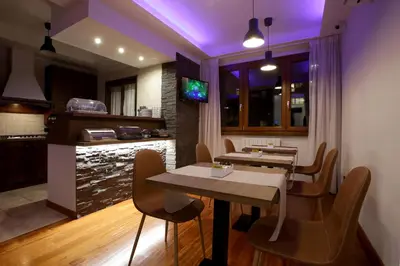 a kitchen and dining room with a table and chairs at J24 B&B in Rome