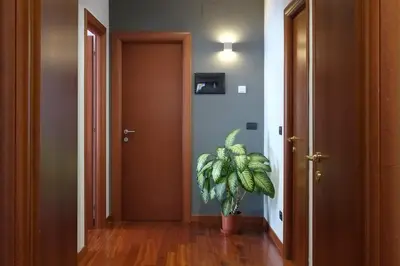 a hallway with a potted plant next to a door at J24 B&B in Rome