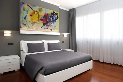 a bedroom with a bed and a painting on the wall at J24 B&B in Rome