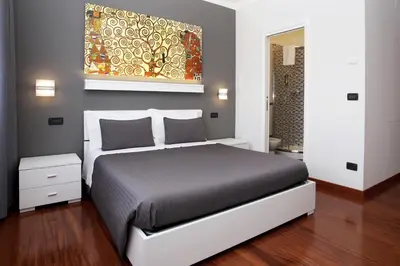 a bedroom with a bed and a painting on the wall at J24 B&B in Rome