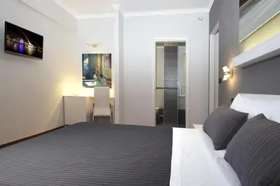 a bedroom with a large bed and a bathroom at J24 B&B in Rome