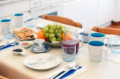 a table with a plate of food and a bowl of fruit at Big House Colosseum in Rome