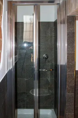 a shower with a glass door in a bathroom at La Casa di Marti in Rome