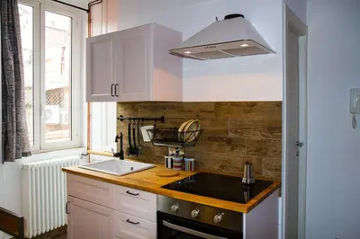 a kitchen with white cabinets and a sink and a window at La Casa di Marti in Rome