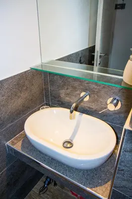 a white sink on a counter with a mirror at La Casa di Marti in Rome