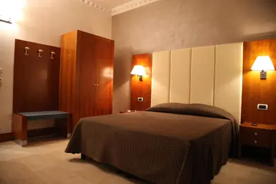 a bedroom with a bed and a cabinet and lights at B&B Federica's House In Rome in Rome