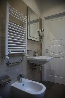 a bathroom with a sink and a mirror at B&B Federica's House In Rome in Rome