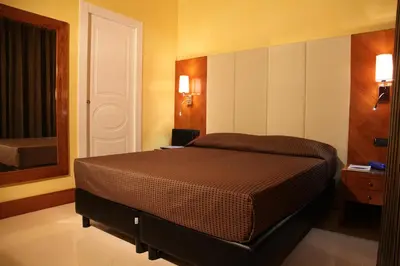 a bedroom with a bed and a mirror at B&B Federica's House In Rome in Rome