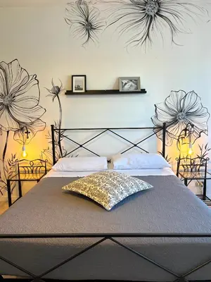 a bedroom with a bed with flowers on the wall at Eufonia Vinyl Friendly Apartment in Rome