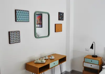 a room with a table and a mirror on the wall at 