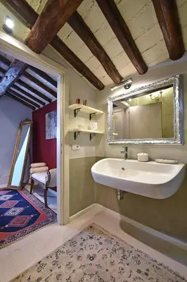 a bathroom with a sink and a mirror at LM Suites Spagna in Rome