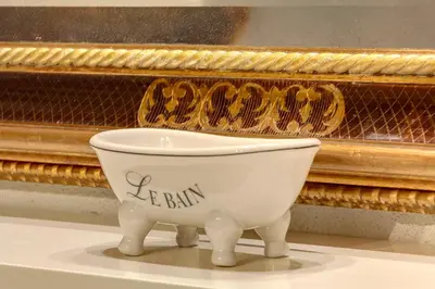 a white bowl sitting in front of a piano at LM Suites Spagna in Rome
