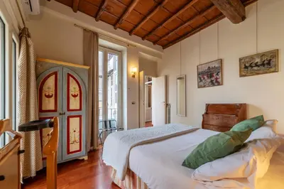 a bedroom with a large white bed in a room at Clock Terrace House in Rome