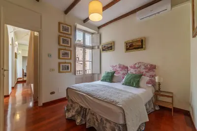 a bedroom with a large bed with green pillows at Clock Terrace House in Rome