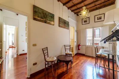 a dining room with a table and chairs in a room at Clock Terrace House in Rome