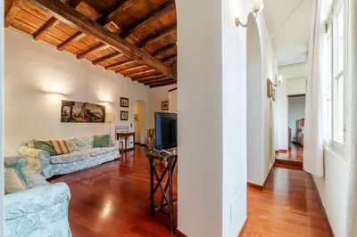 a living room with a couch and a table at Clock Terrace House in Rome