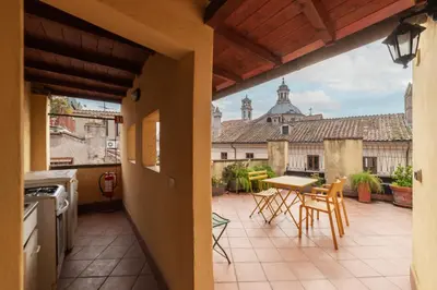 a kitchen with a table and chairs on a patio at Clock Terrace House in Rome