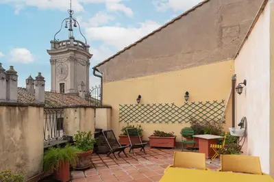 an outdoor patio with a clock tower in the background at Clock Terrace House in Rome