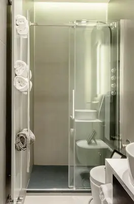 a bathroom with a shower with a toilet and a sink at Private Apartment Colosseum in Rome