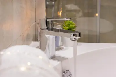 a silver faucet on a sink in a bathroom at Private Apartment Colosseum in Rome