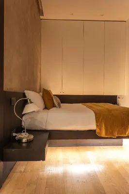 a bedroom with a bed and a table with a lamp at Private Apartment Colosseum in Rome