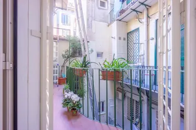 a balcony with potted plants on a building at Private Apartment Colosseum in Rome