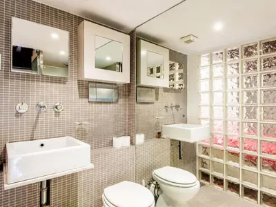 a bathroom with a sink and a toilet and a tub at RSH Balestrari Apartments in Rome