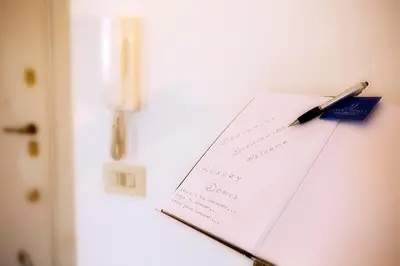a pen on a piece of paper on a refrigerator at Luxury Domus Amadeus in Rome