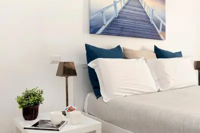 a bedroom with a bed and a picture of a staircase at Maison Piazza Cavour in Rome