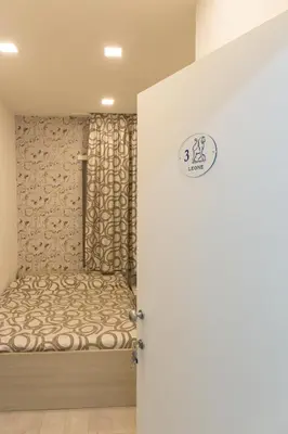 a room with a bed with a sign on the door at Metronia Guest House in Rome