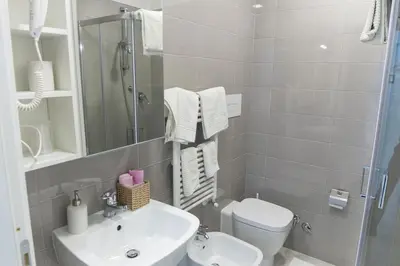 a bathroom with a sink and a toilet and a shower at Metronia Guest House in Rome