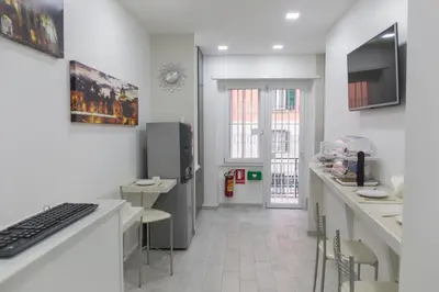 a kitchen with a desk with a keyboard and a computer at Metronia Guest House in Rome
