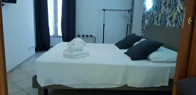 a white bed with a towel on top of it at Campo de Fiori House in Rome
