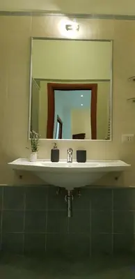 a bathroom with a sink and a mirror at Campo de Fiori House in Rome