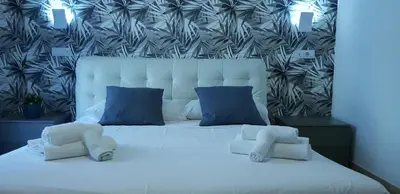 a bedroom with a white bed with blue pillows at Campo de Fiori House in Rome