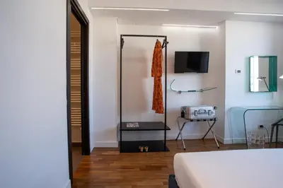 a hotel room with a bed and a television at PgrHome Riverside in Rome