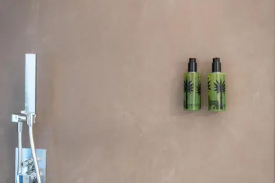 two green bottles are hanging on a wall at PgrHome Riverside in Rome