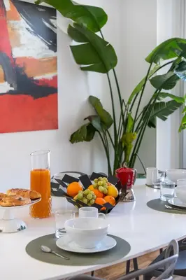 a table with a plate of fruit on it at PgrHome Riverside in Rome