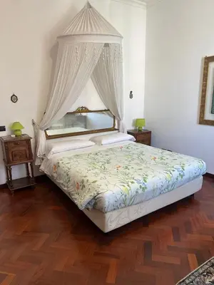a bedroom with a bed with a canopy at Appartamento Fiore in Rome