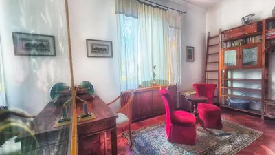 a living room with a red chair and bunk beds at Appartamento Fiore in Rome
