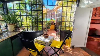 a bedroom with a bed and two red chairs at Appartamento Fiore in Rome