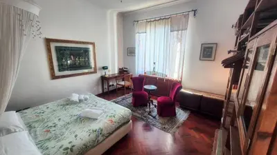 a bathroom with a tub and a toilet and a sink at Appartamento Fiore in Rome