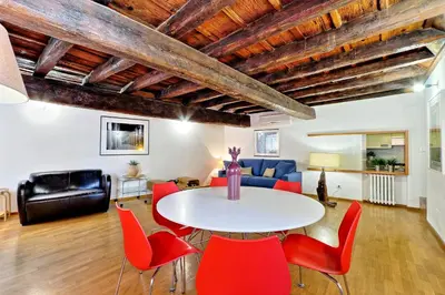 a living room with a white table and red chairs at Parione Charme - My Extra Home in Rome