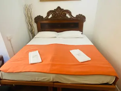 a bed with two white towels sitting on it at Roman Place in Rome